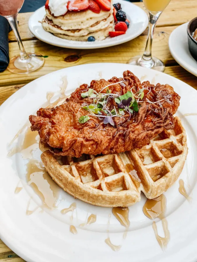 Fried chicken and waffles drizzled with syrup