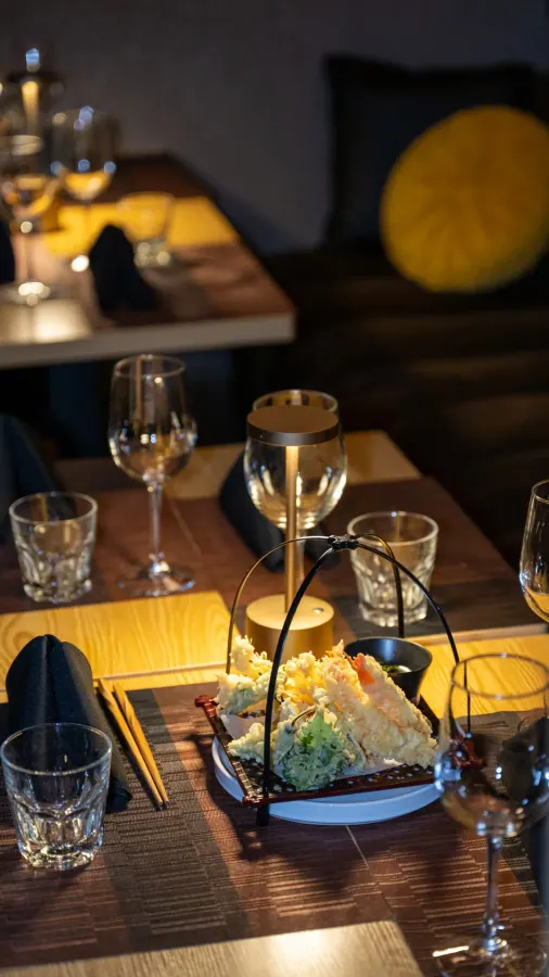 Restaurant table set with wine glasses and a small lamp