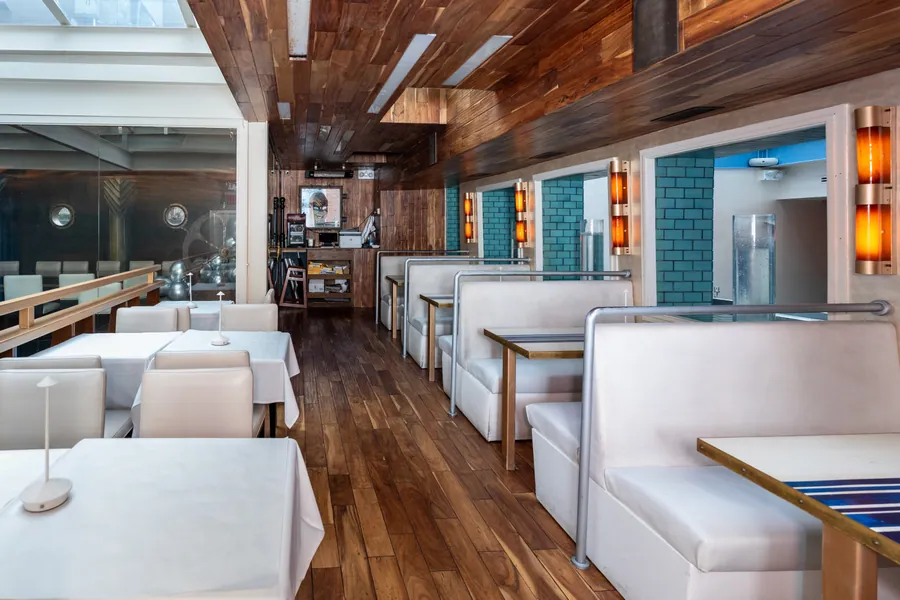 Aquarelle's booths and dining room, walnut ceiling and amber sconces