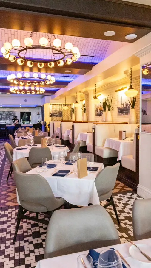 Dining room with white tablecloths and blue chairs