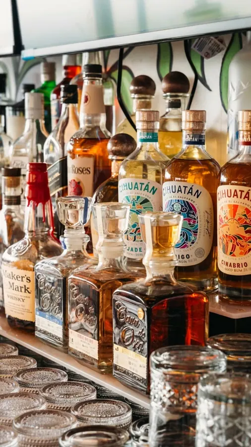 Bottles of tequila and bourbon on a back bar