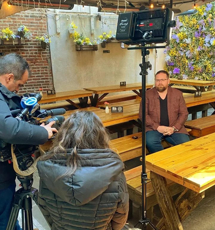 Doug Jacobson being filmed for an interview in the garden at Loreley Beer Garden