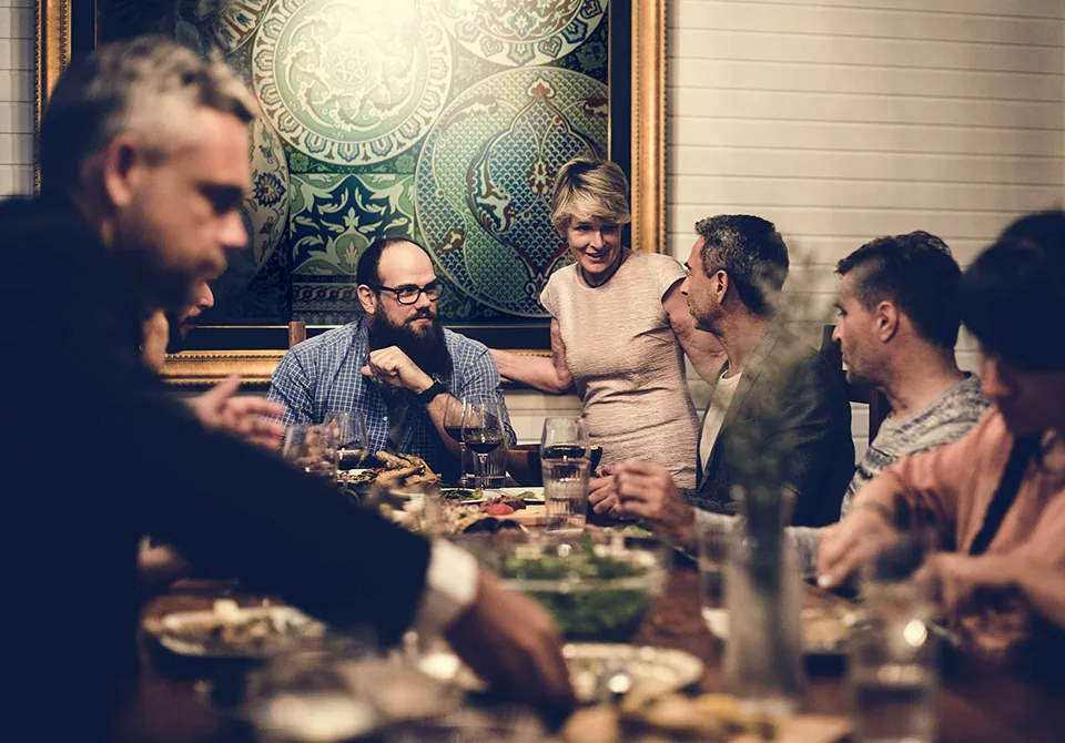 A long table of guests at a private dinner