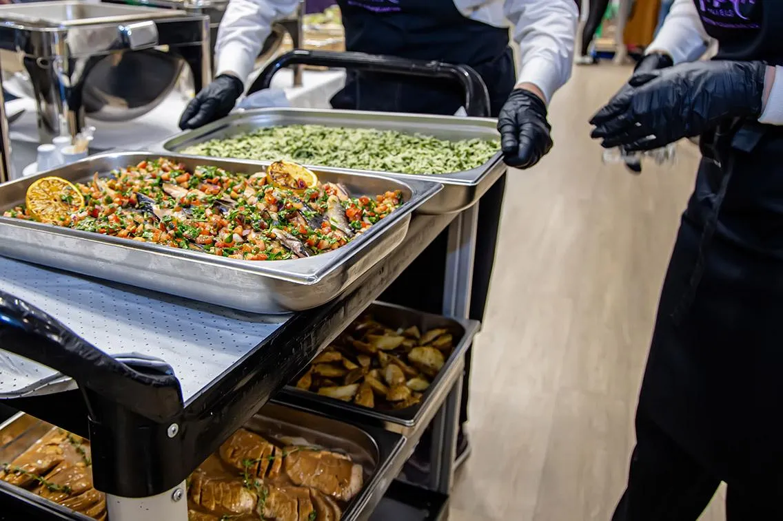 Catering trays being carried to an event