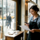 Restaurant owner posts social update at front window