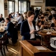 Restaurant manager moving through lively dining room