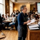 Restaurant owner checking reservations at host podium
