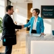 Manager greeting loyal restaurant guest at entry