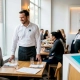 Restaurant manager greets returning customers