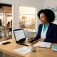 Restaurant manager at desk reviewing digital bookings