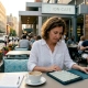 Restaurant owner reading guest reviews in café