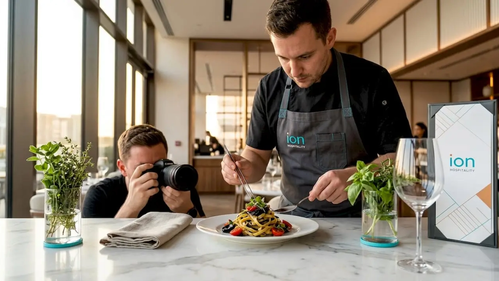 Chef and photographer at window table