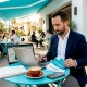 Restaurant owner reviewing marketing agency proposals in café