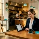 Restaurant manager checking online orders at table
