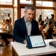 Restaurant owner reviewing loyalty data on tablet