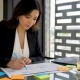 Restaurant manager planning content calendar at table