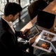 Consultant comparing restaurant marketing agency materials