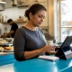 Restaurant owner managing digital orders on tablet