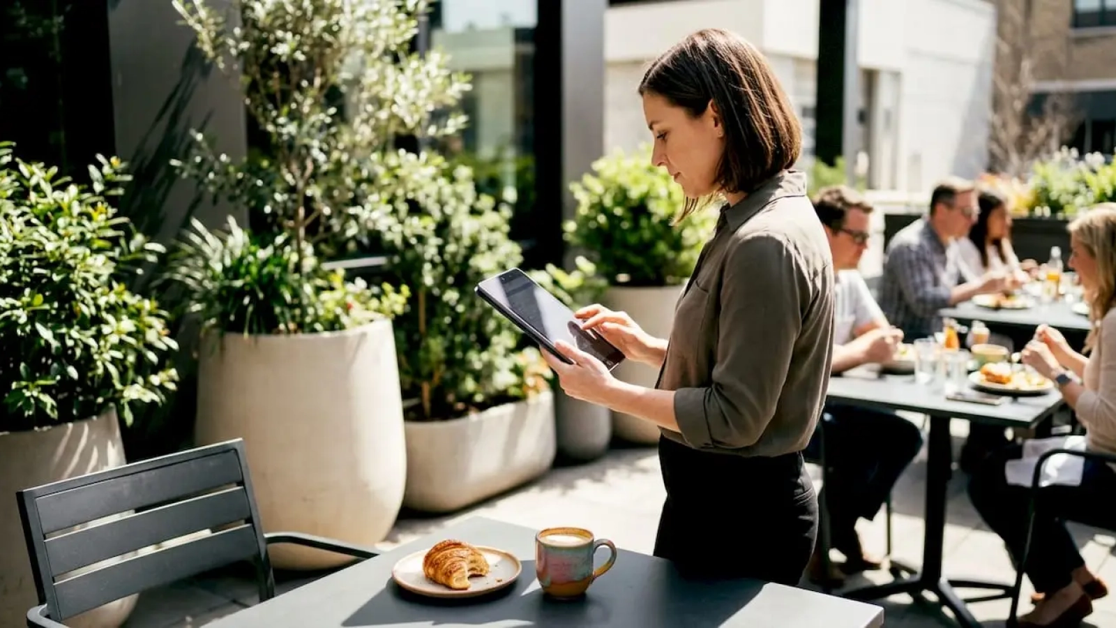 Restaurant manager reviewing marketing data on tablet