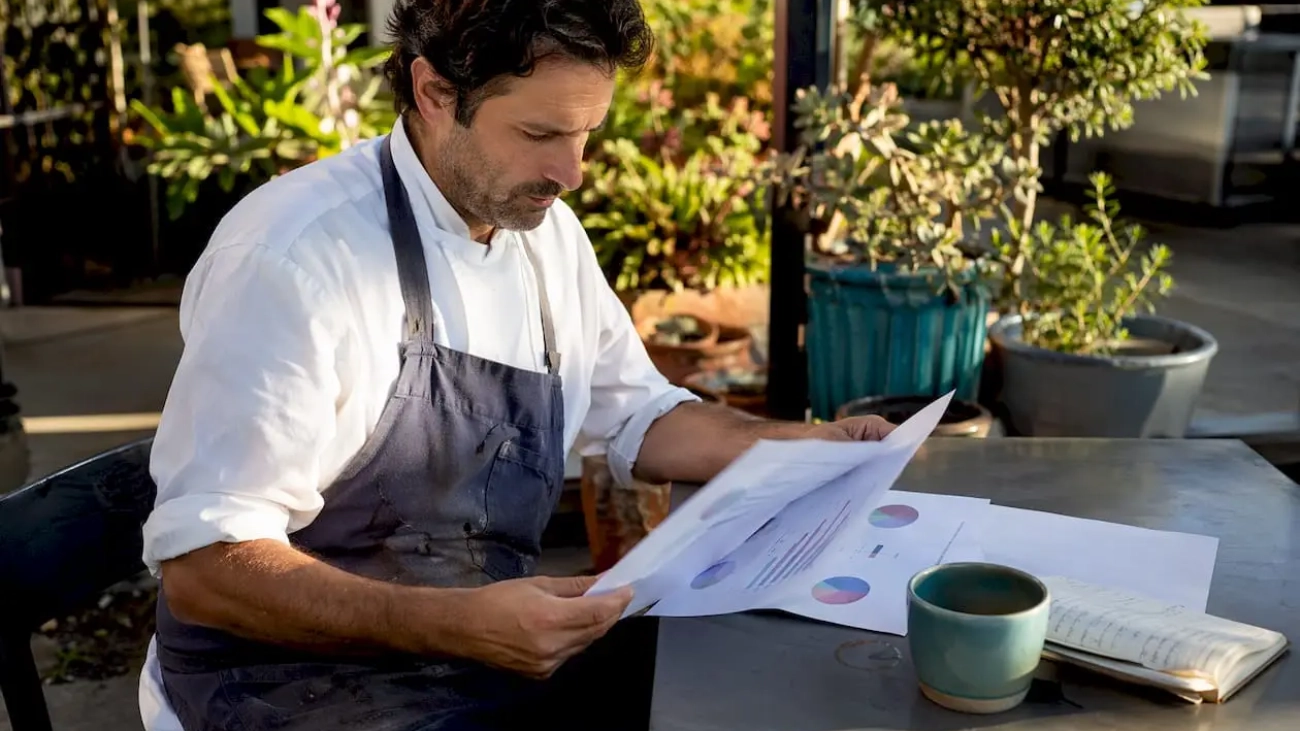Restaurant owner reviewing marketing strategy at table