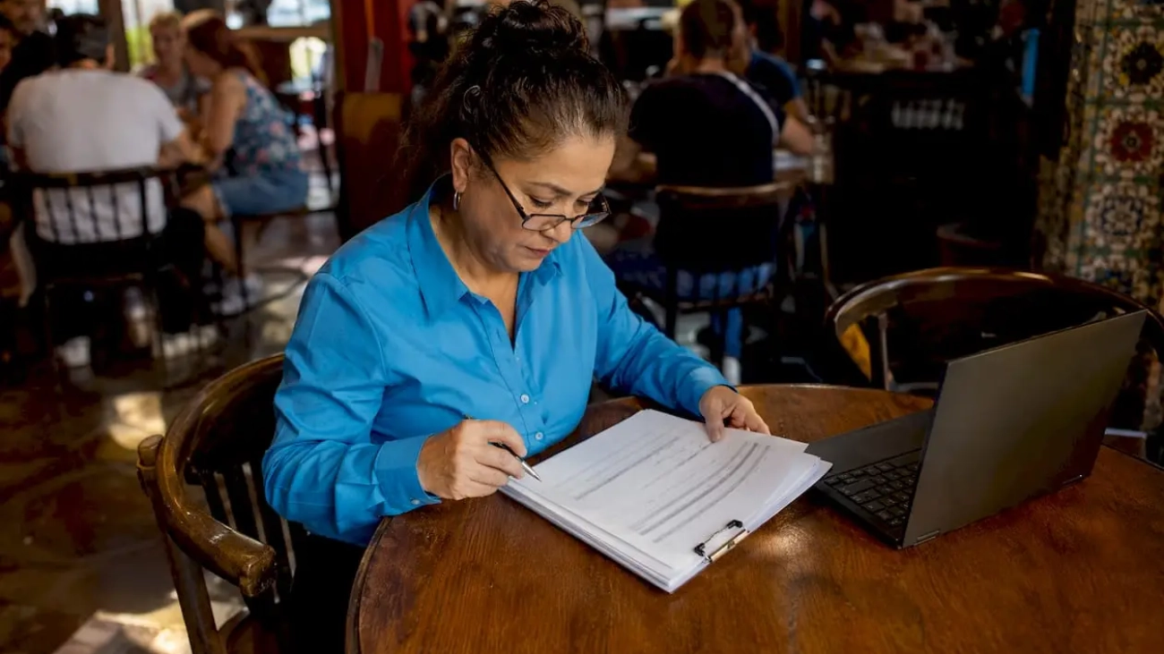 Restaurant manager reviewing appliance alternatives list