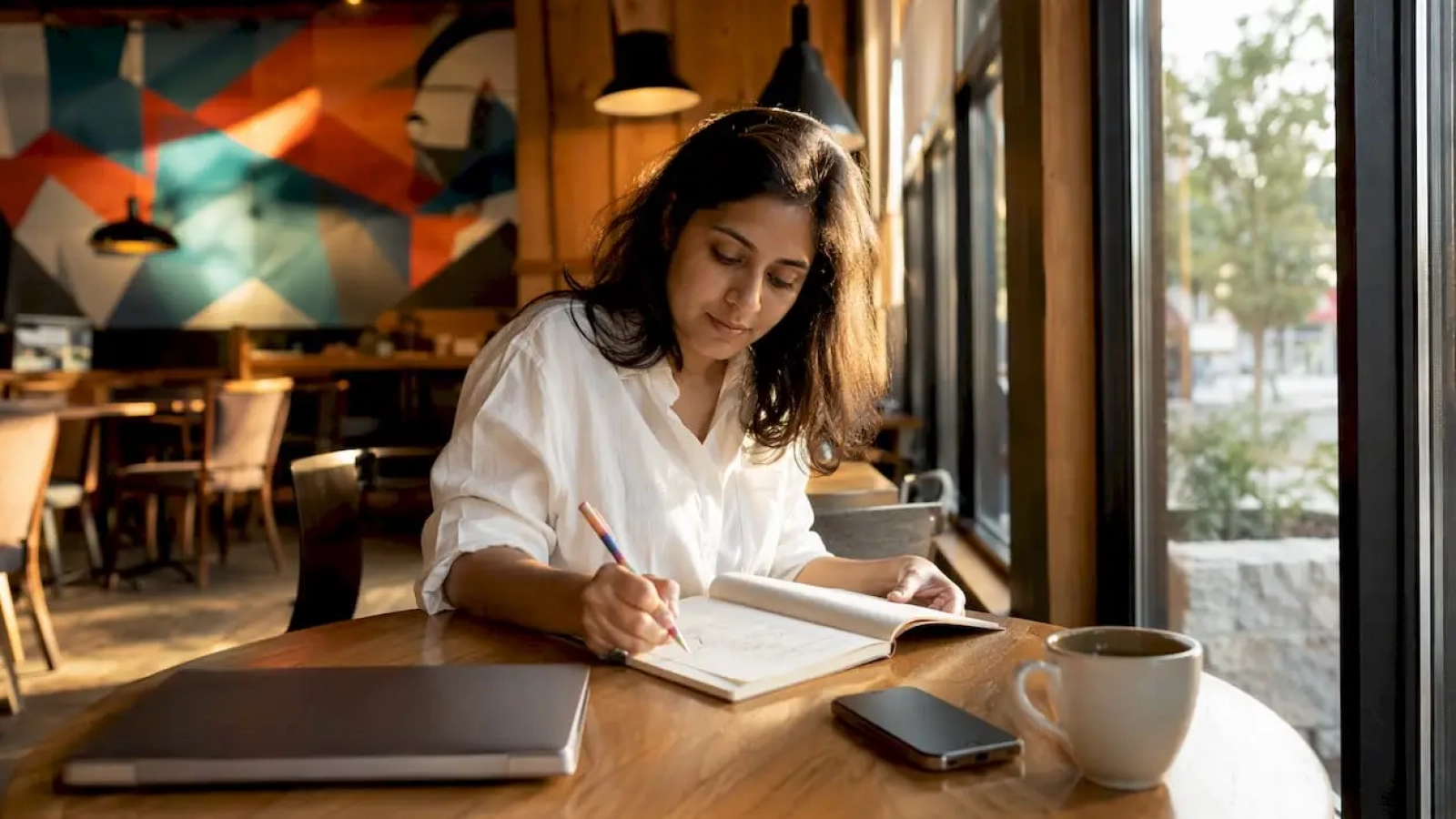 Woman crafting brand storytelling notes in co-working space