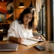 Woman crafting brand storytelling notes in co-working space