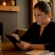 Restaurant manager using tablet to read reviews