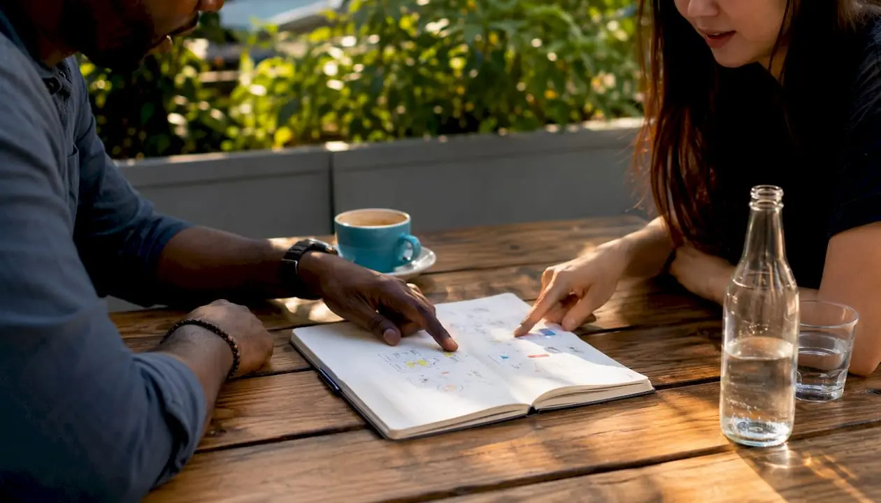 Hands pointing at tablet during restaurant marketing analysis