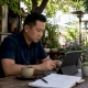 Restaurant owner reviewing marketing analytics on tablet