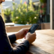 Hands holding smartphone in restaurant office