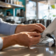 Hands connecting network cables at restaurant POS