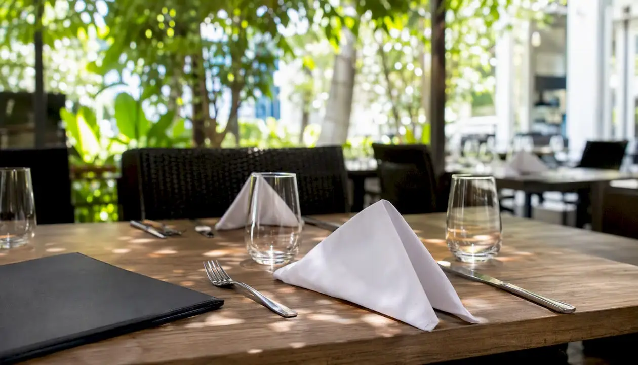 Private dining table set with glassware and linen napkin